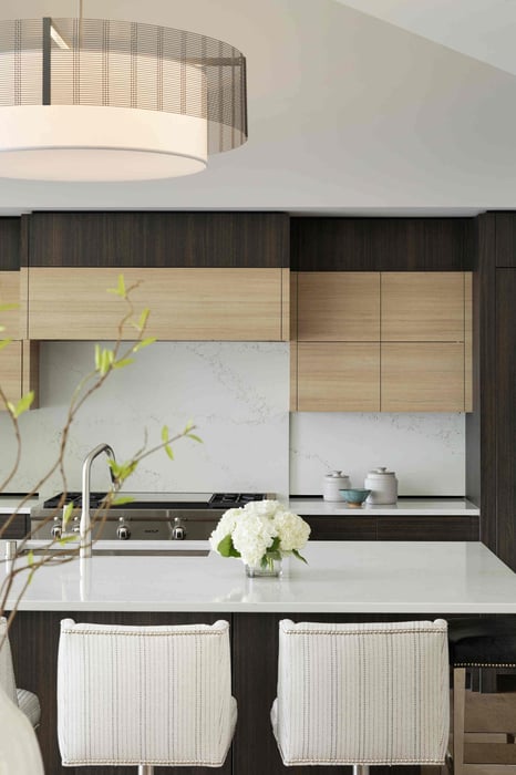 Modern kitchen with wooden cabinets and white countertops in a custom home by MA Peterson, Twin City