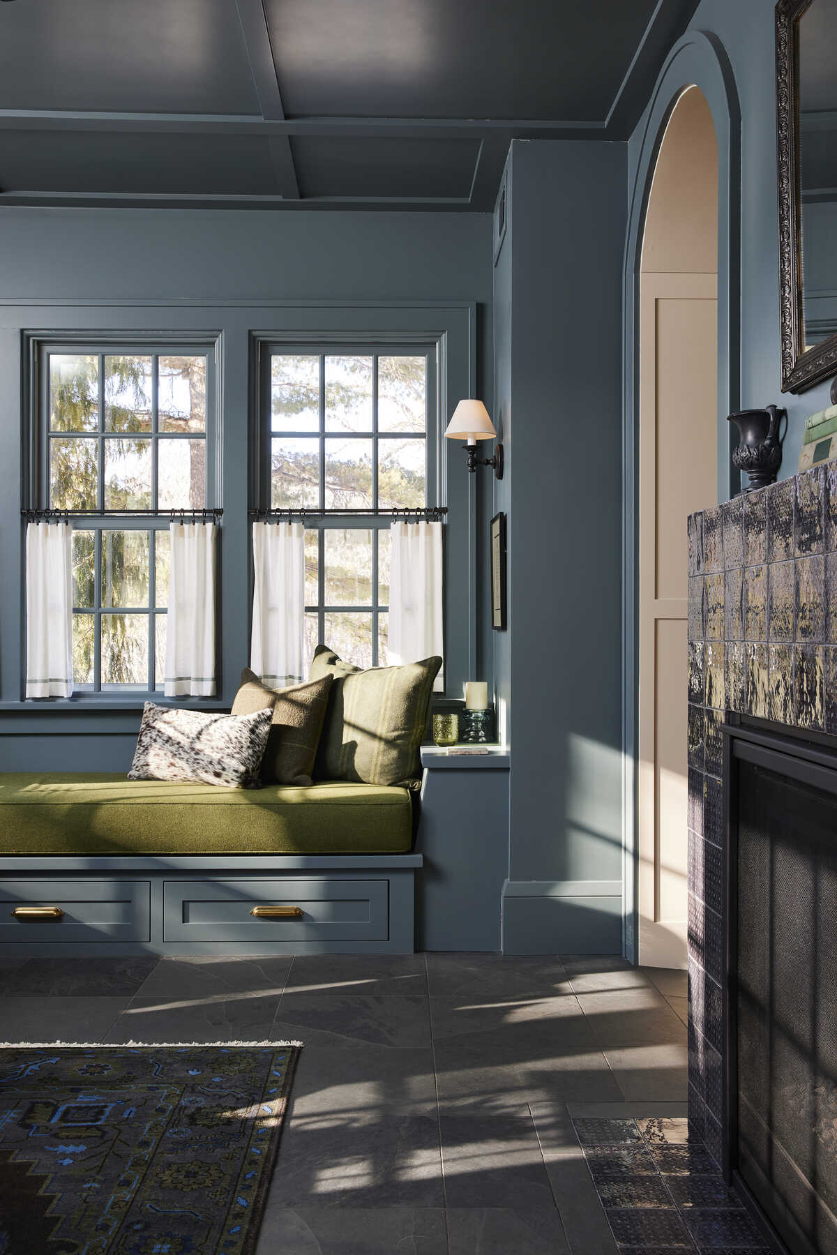 Cozy reading nook with green bench and blue walls, MA Peterson interior design in Twin City Cozy reading nook with green bench and blue walls, MA Peterson interior design in Twin City