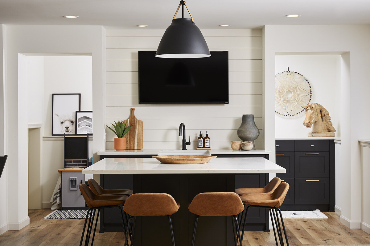 Stylish basement bar area with leather stools, designed by MA Peterson in Twin City