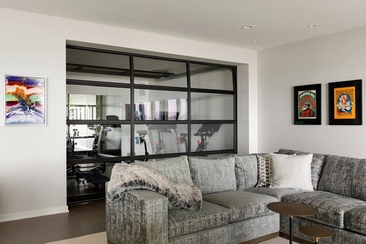 Modern exercise room with a glass partition and Peloton bikes, designed by MA Peterson in the Twin Cities-1