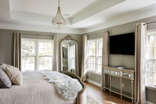 Luxurious bedroom with a chic chandelier and large mirror, designed by MA Peterson, Twin Cities