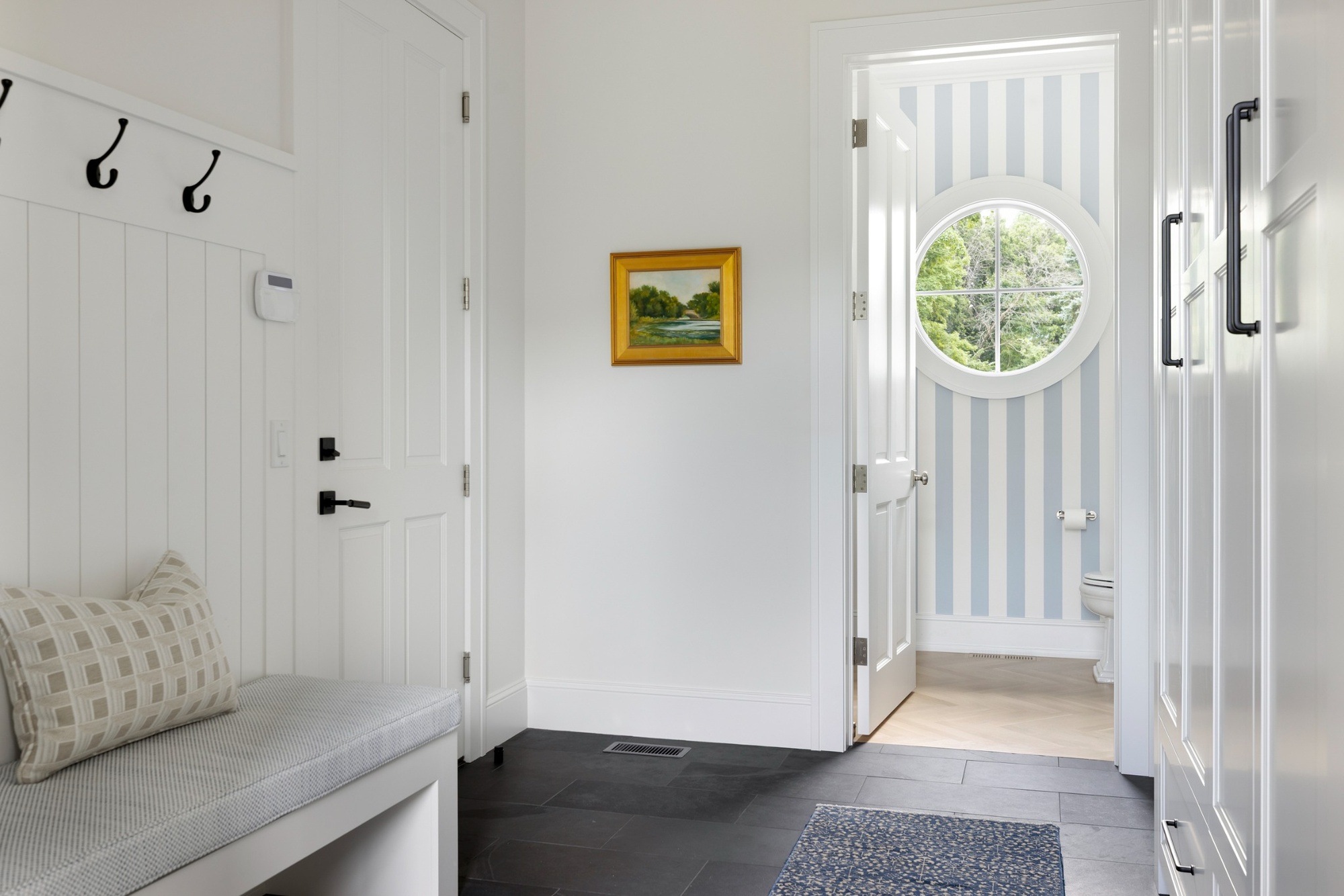 custom home mudroom with built in bench and powder room in wayzata mn