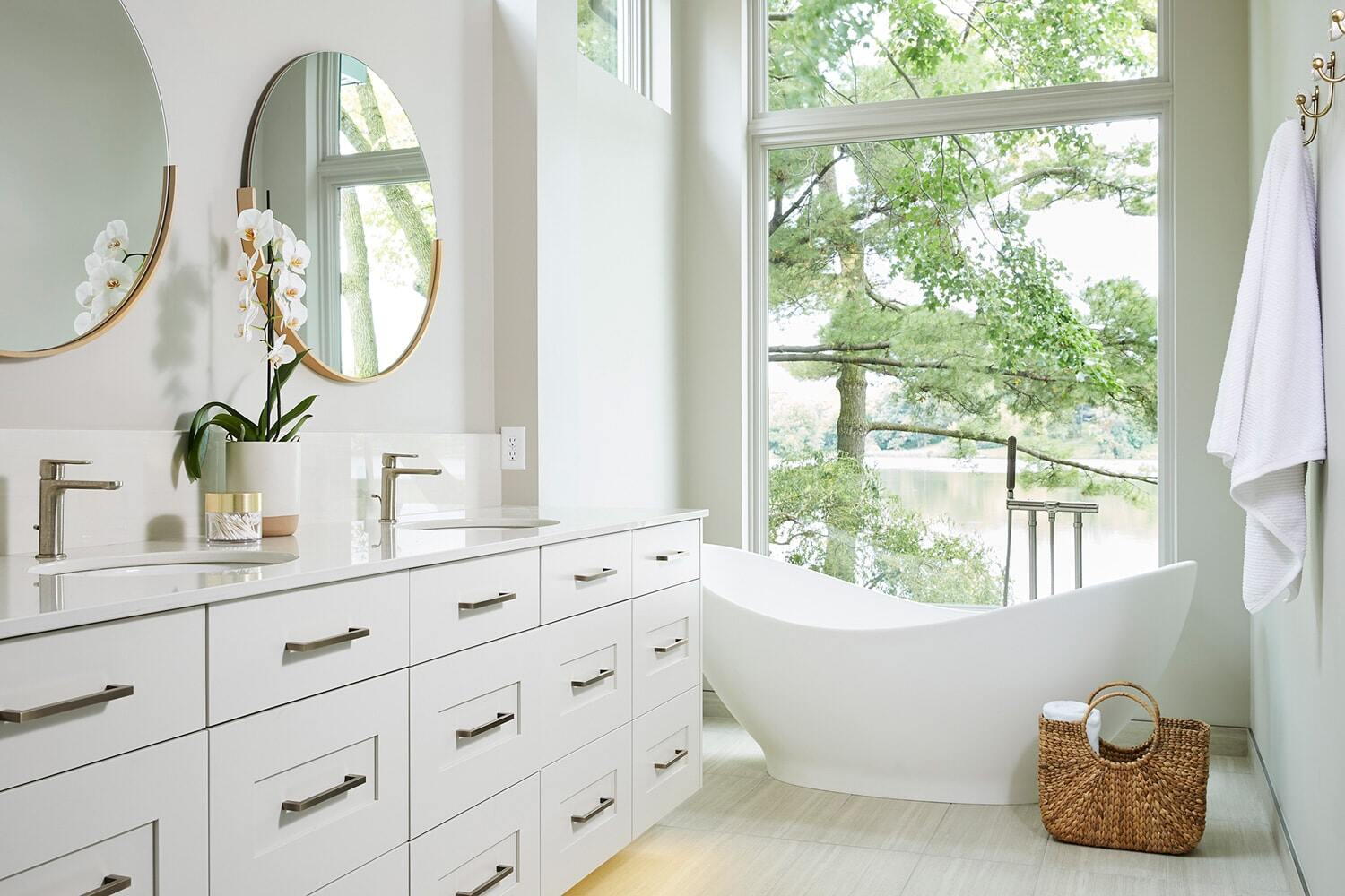 Dual vanity bathroom with lake view in Lake Cornelia home by MA Peterson, Twin Cities