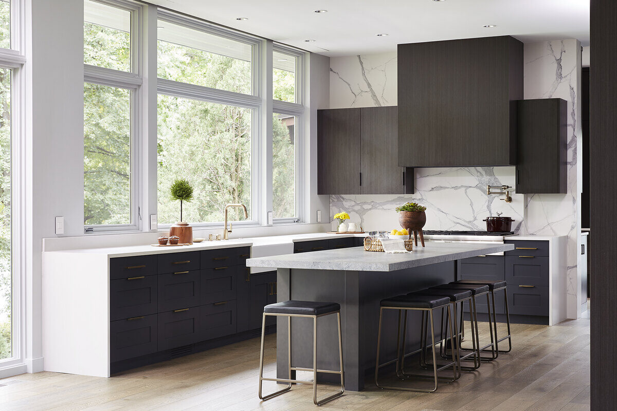 Modern kitchen with large windows and dark cabinetry in a Twin Cities remodel by MA Peterson