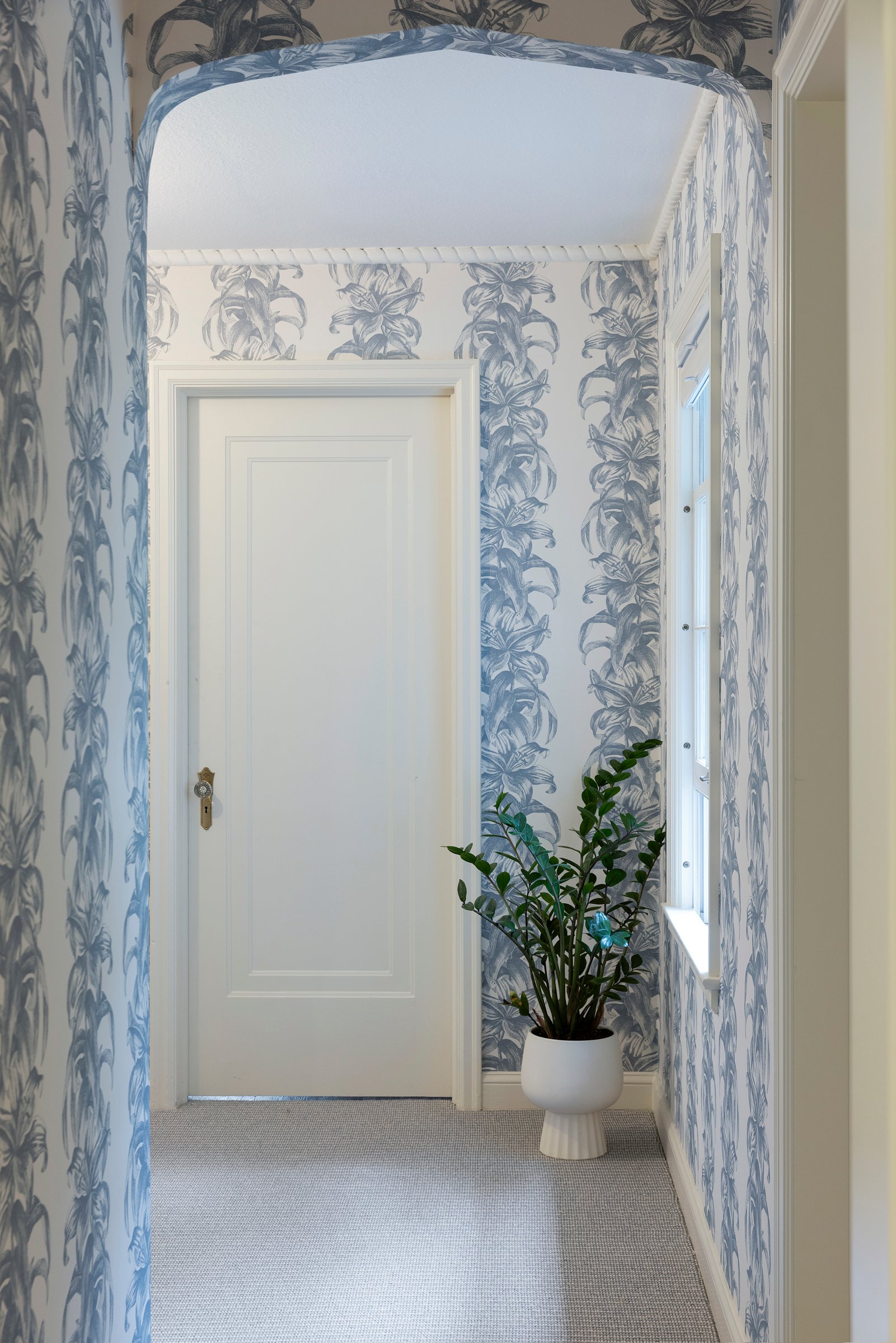 Decorative wall nook showcasing wallpaper and custom trim