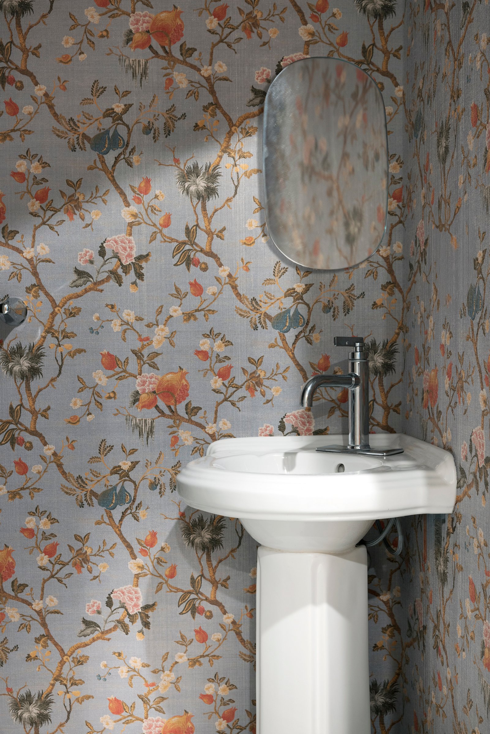 Bathroom with floral wallpaper accent and custom vanity design