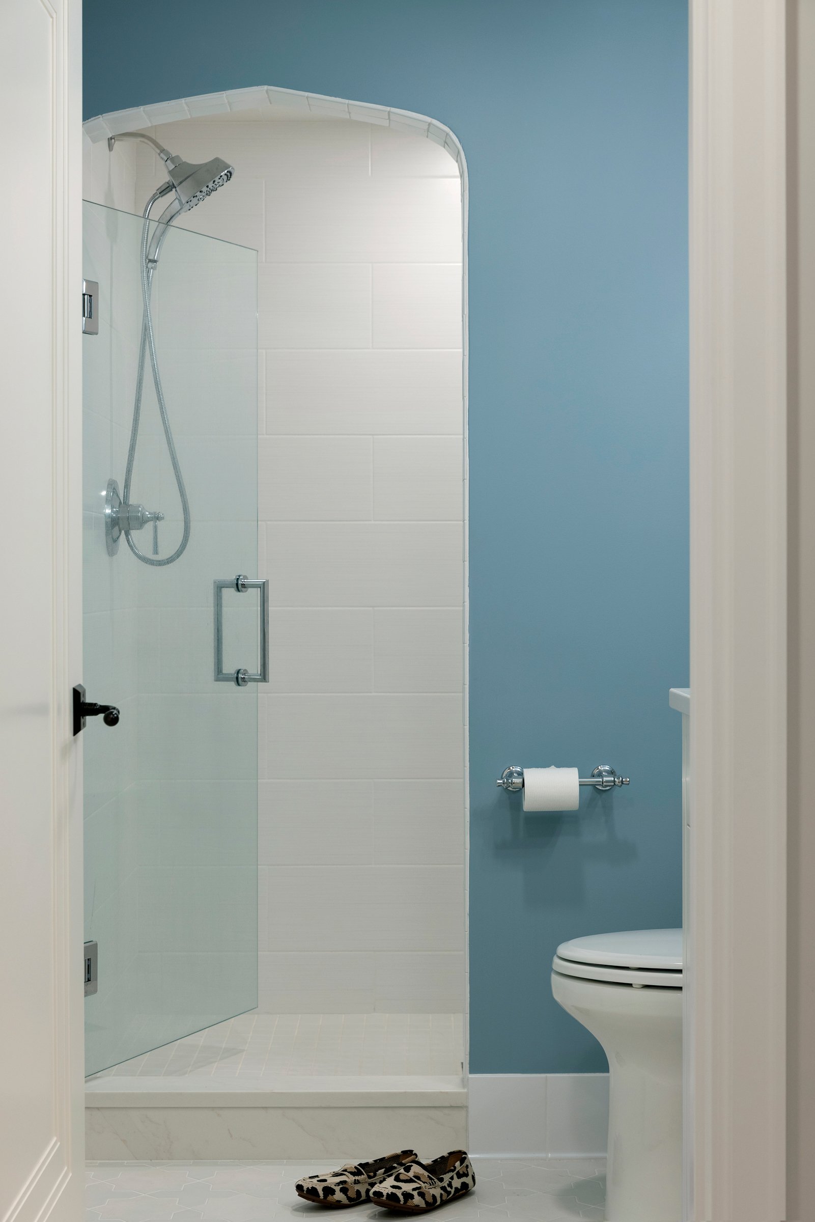 Spa-inspired bathroom with walk-in shower, large-format tile, and frameless glass enclosure