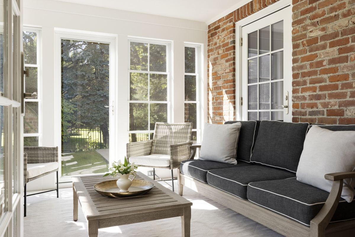 Remodeled three-season porch with new energy-efficient windows and natural wood ceiling.