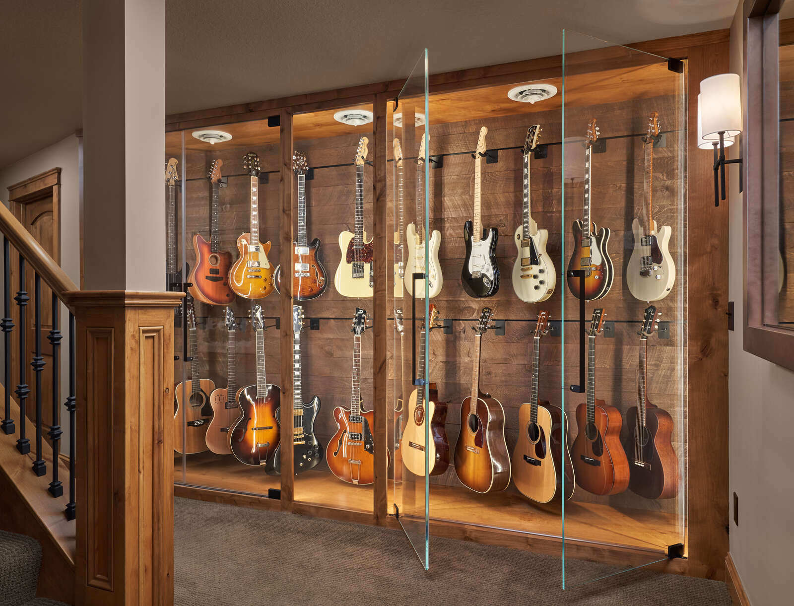 Stylish room featuring a collection of guitars in a glass case, MA Peterson, Twin City