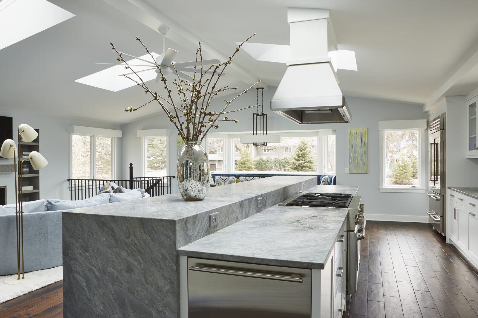 Bright open-concept kitchen with marble countertops and large windows in a custom home by MA Peterson, Twin City