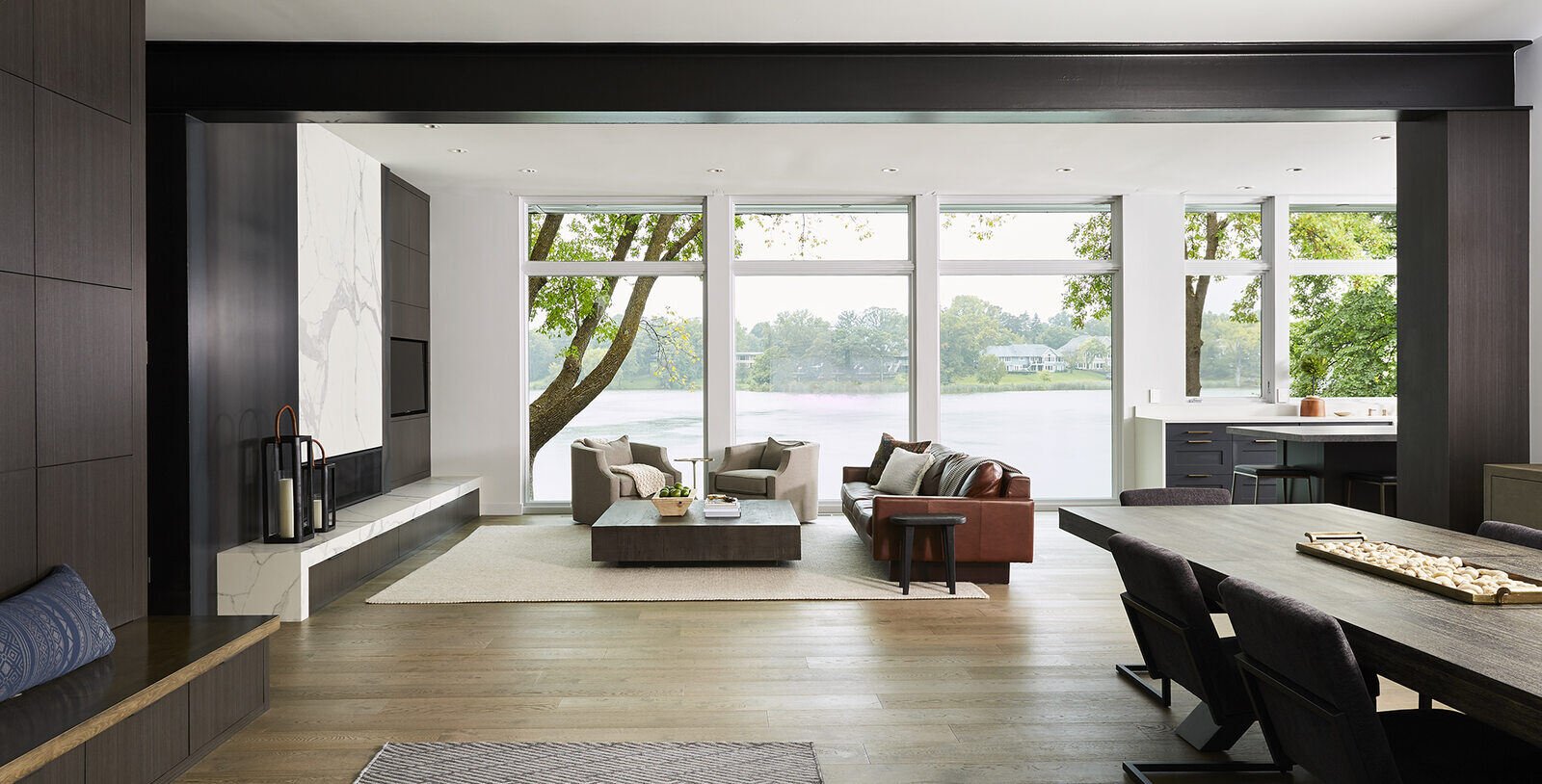 Open-concept living space with lake views and contemporary decor in a custom home by MA Peterson, Twin City