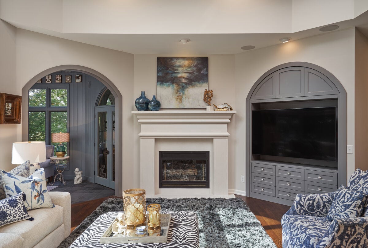 Contemporary living room with arched doorways and fireplace, designed by MA Peterson in Twin City