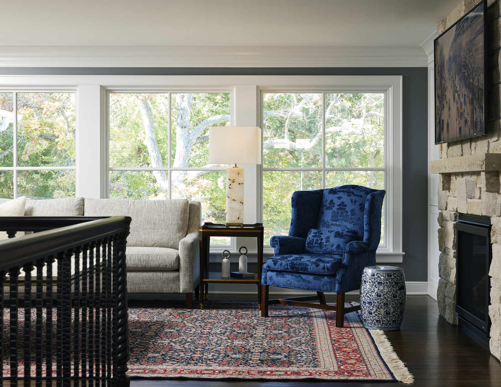 Elegant living room with large windows and blue armchair, designed by MA Peterson in Twin City