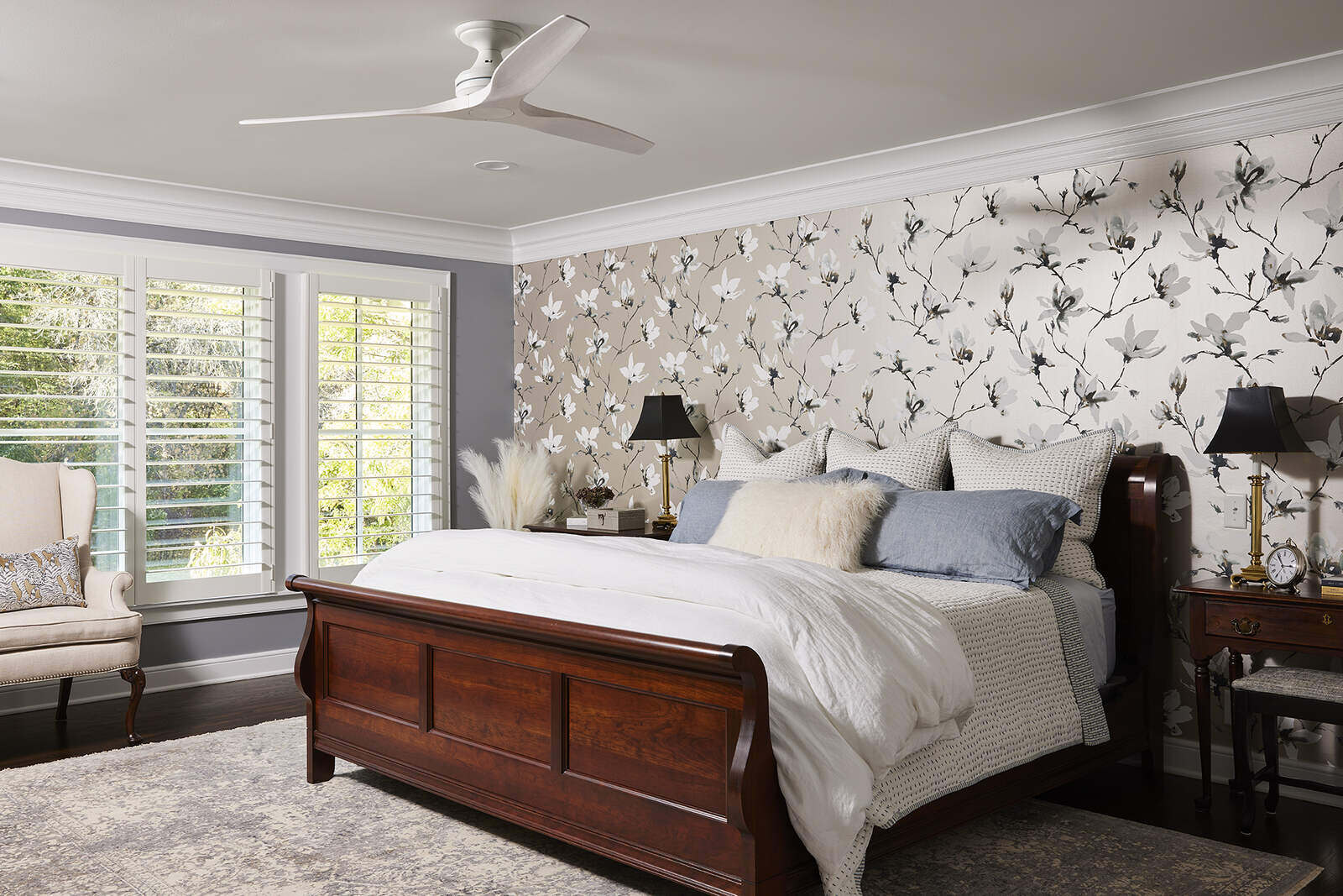 Luxurious bedroom with floral wallpaper and wooden bed, designed by MA Peterson in Twin City