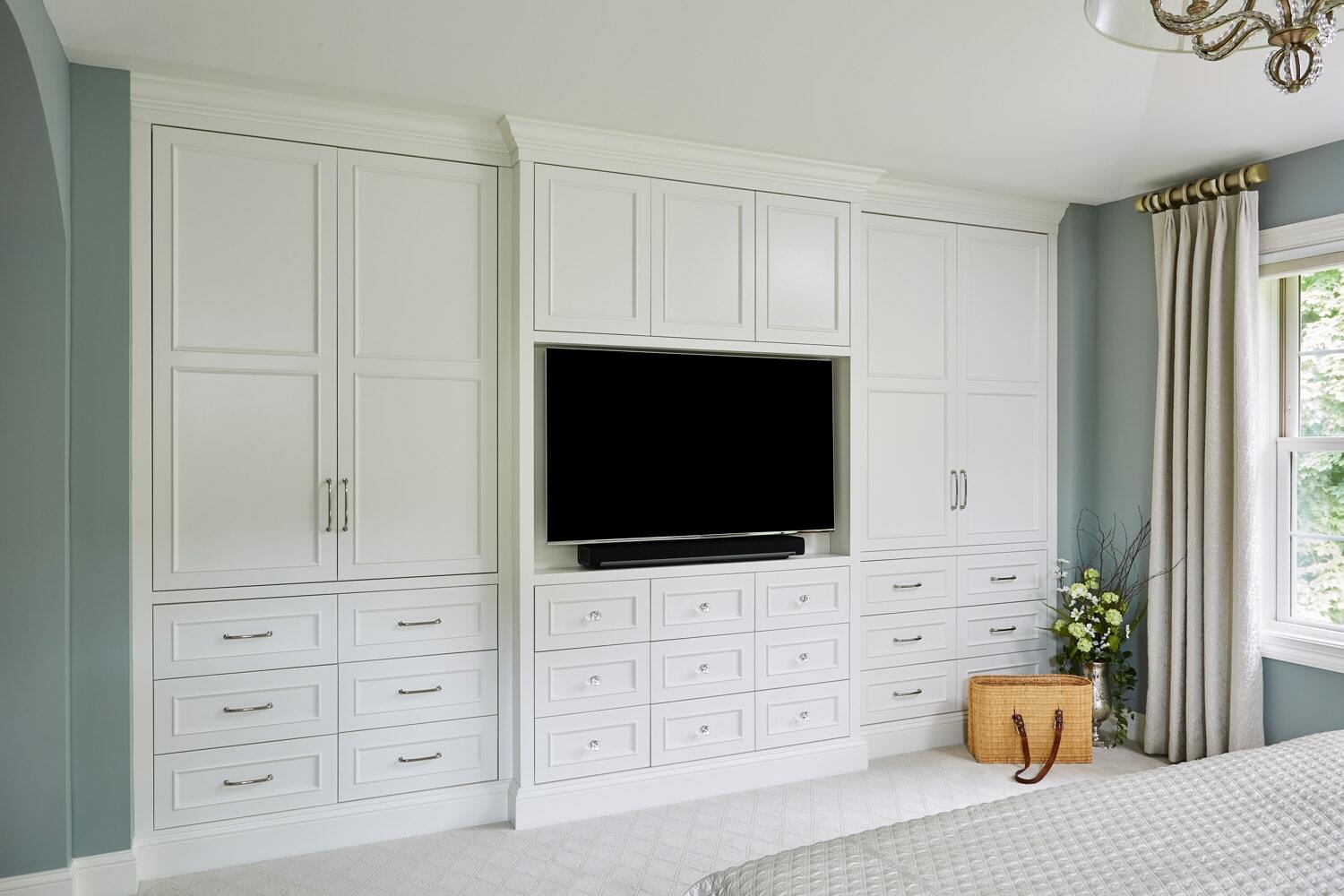 Custom entertainment center with white cabinetry in a Twin Cities owners suite
