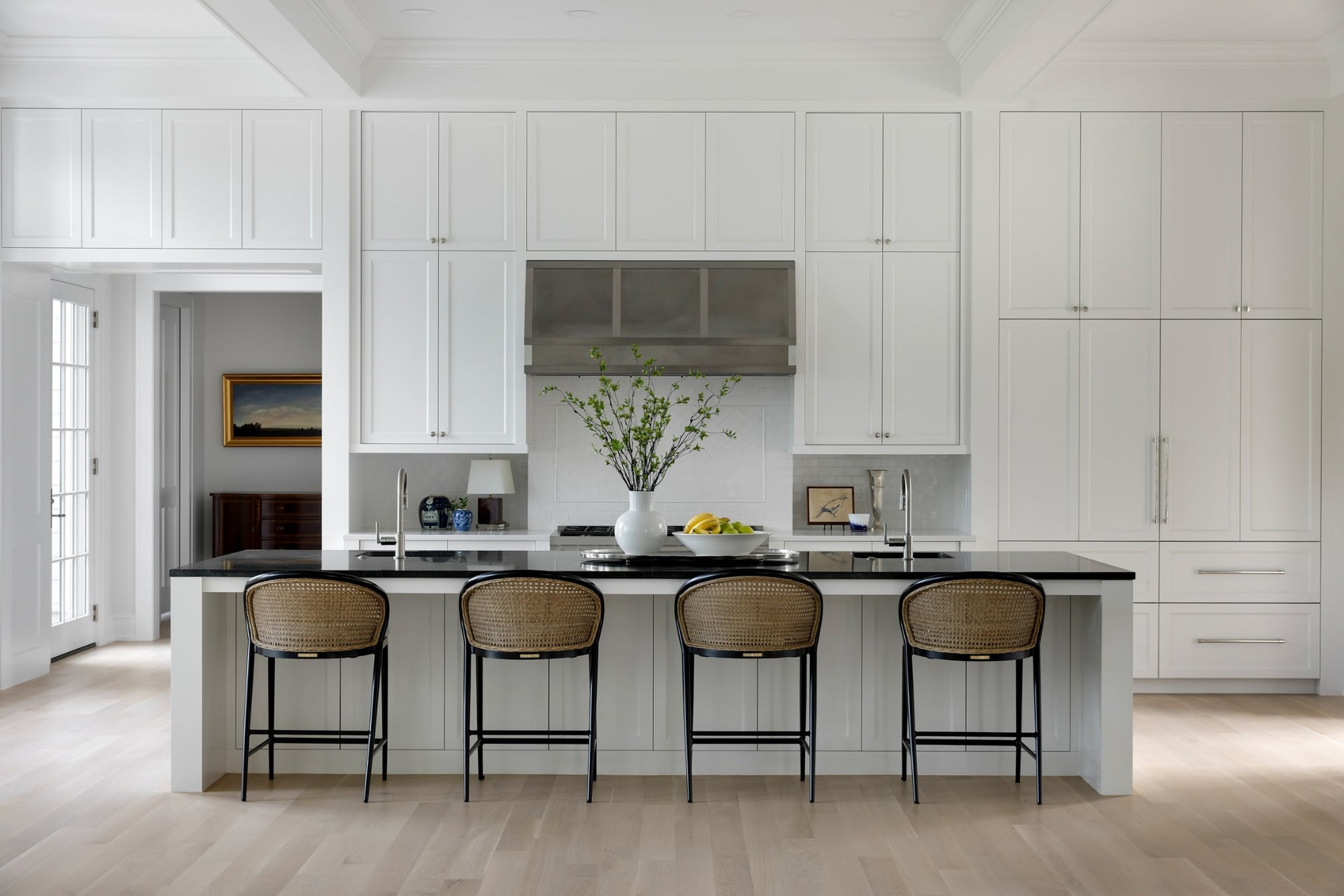 wayzata mn custom home kitchen island with black countertop cane stools and white cabinets wayzata mn custom home kitchen island with black countertop cane stools and white cabinets