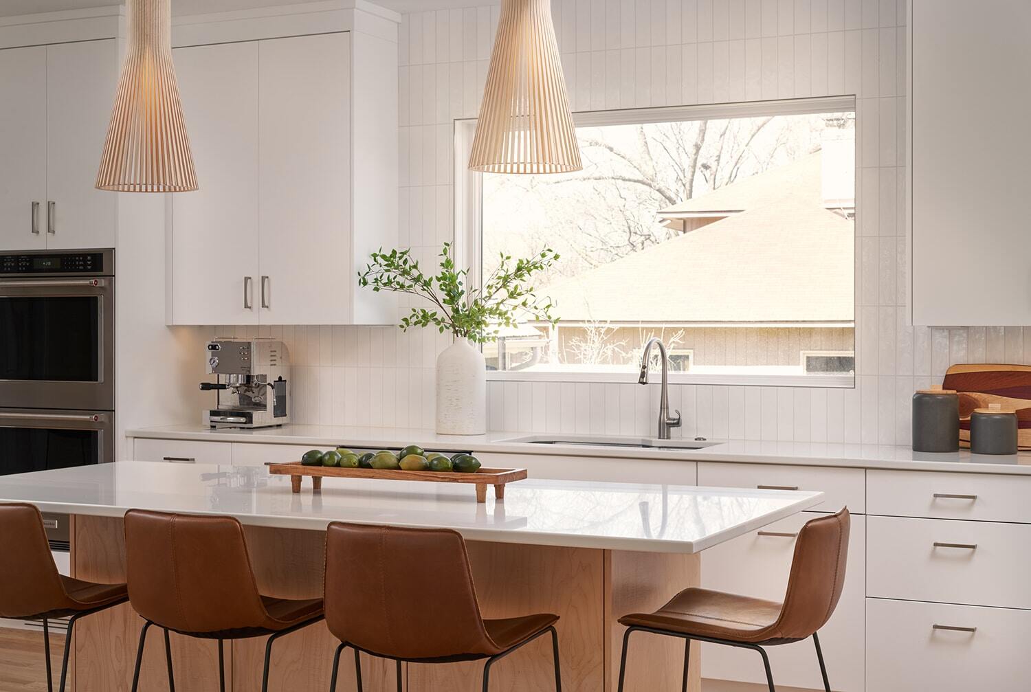 Bright Twin Cities kitchen with an island and large window, remodeled by MA Peterson